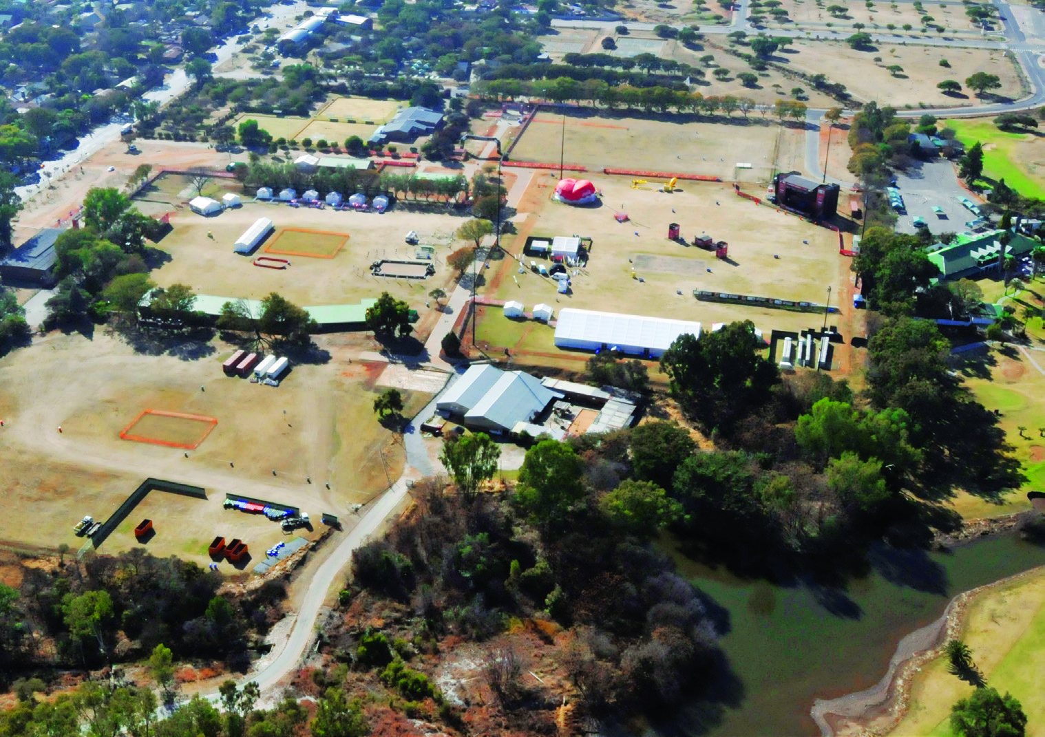 Aerial view of the fan park grounds with marquees, stages and open fields.