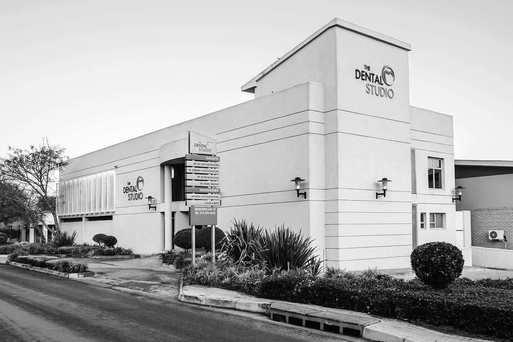 Rendered dental practice building on a corner site with landscaped frontage.