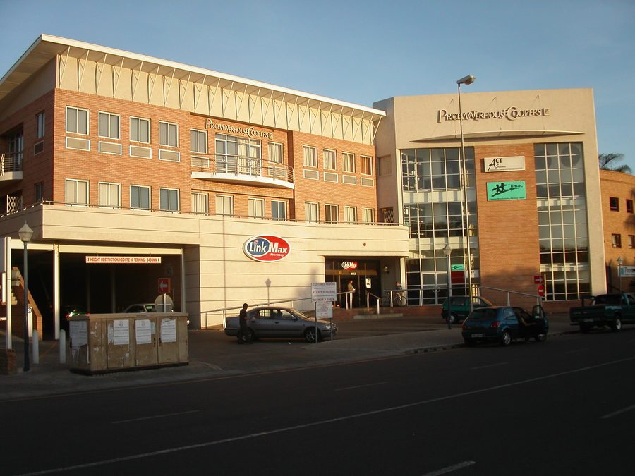 Street view of the face-brick office building with its entrance canopy and signage.