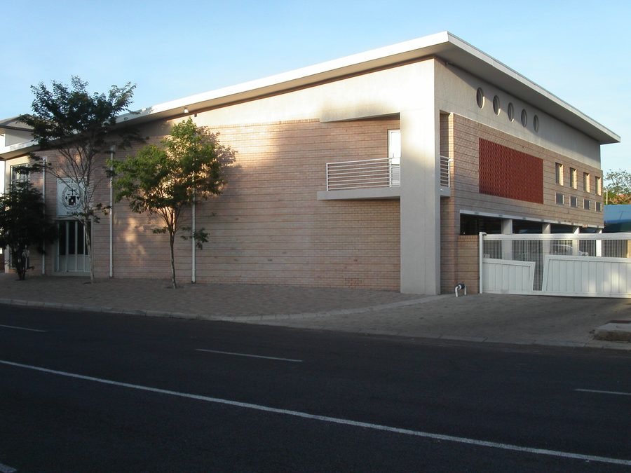 Side street elevation of the two-storey office building with a deep roof overhang.