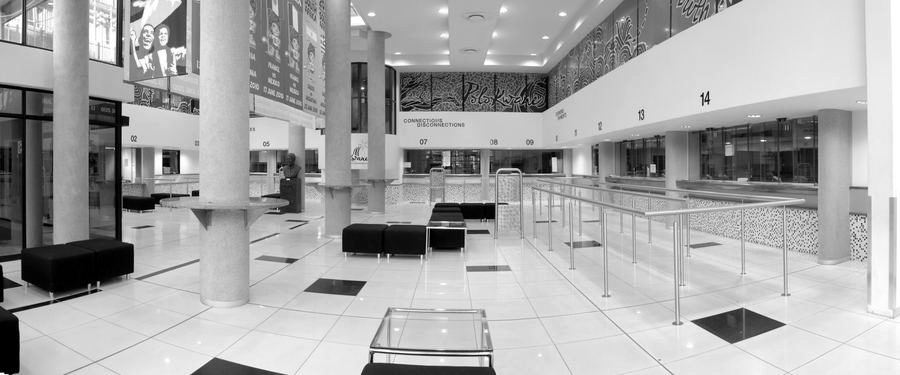 Public hall seen along its length, with service counters on the right and a high-level window band.
