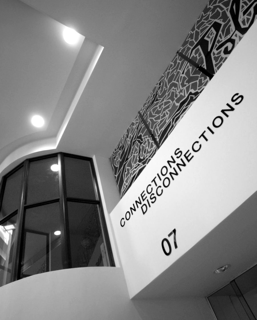 Upper wall of the hall carrying a printed graphic panel above a numbered service point.